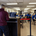 Associate speaking at a podium during program launch.