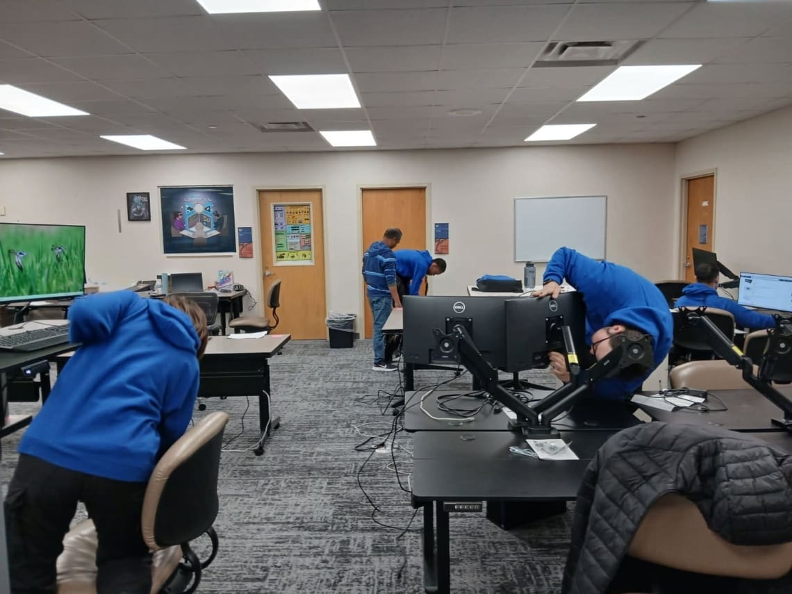 Associates working at computers in an IT classroom.
