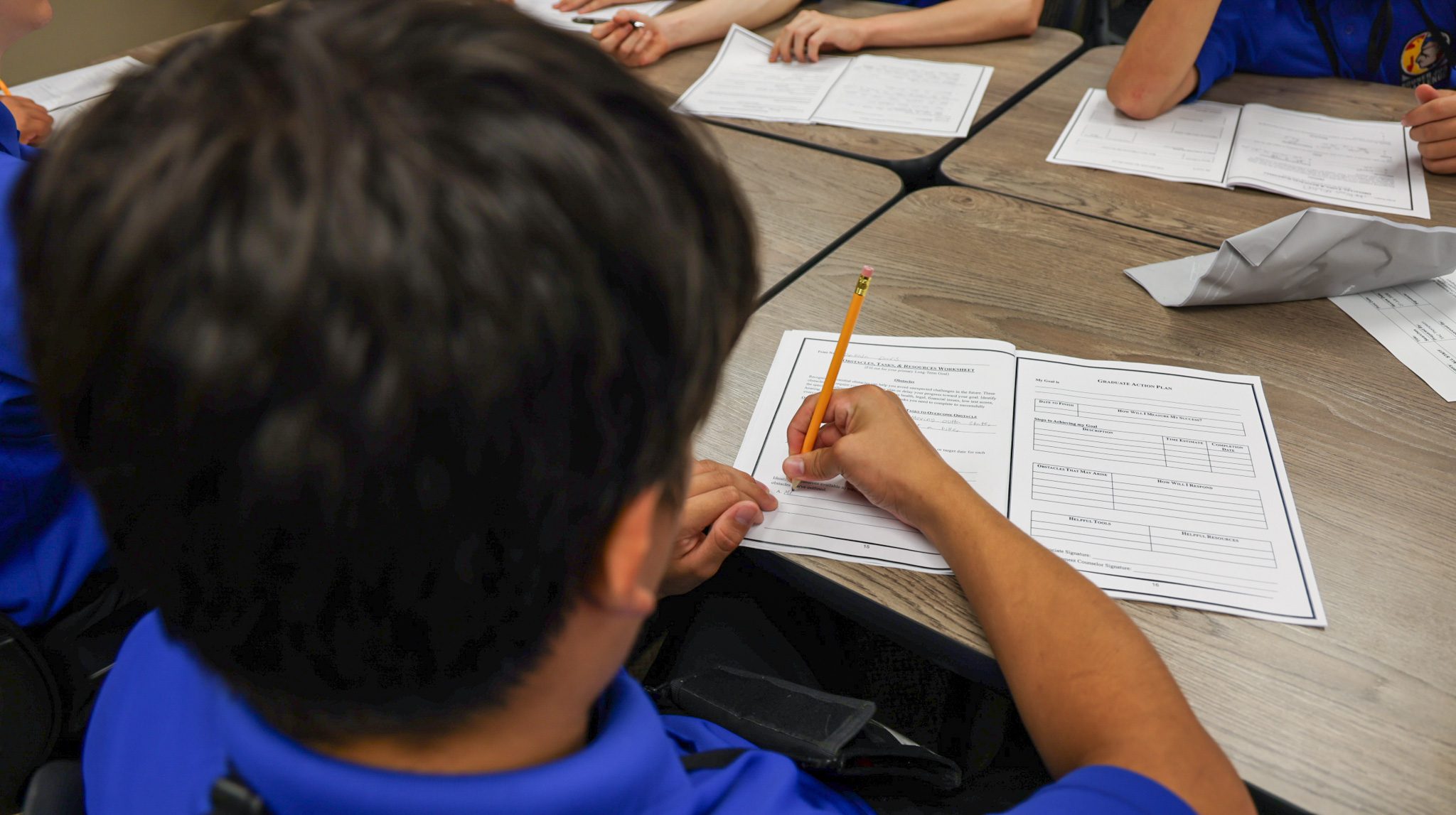 Student writing in a booklet.