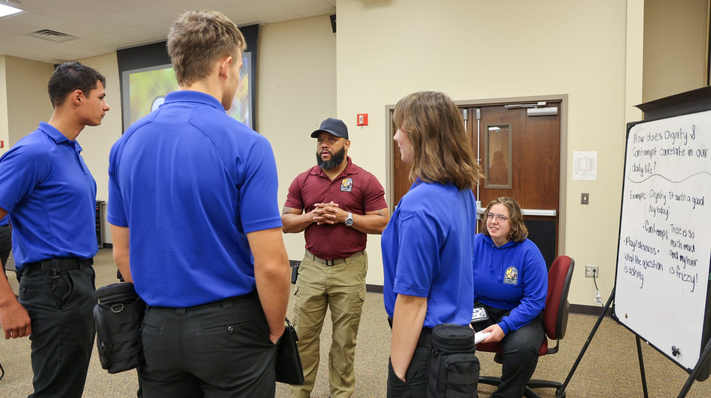 Man speaking to a group of students.