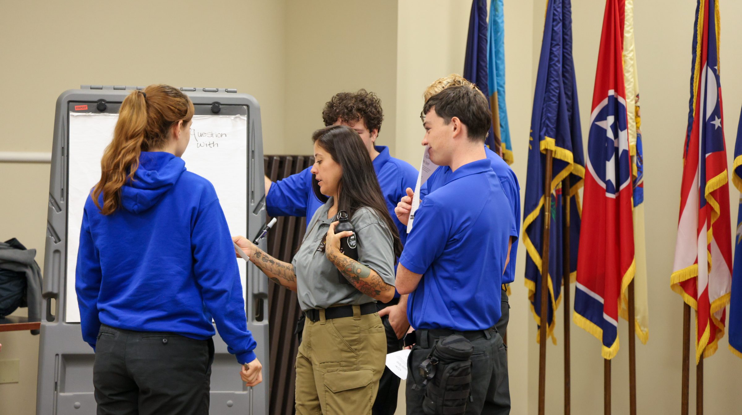 Woman speaking to a group of students.
