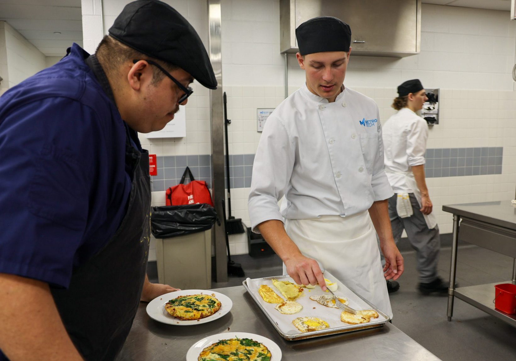 Male student showing the Chef his completed cooked eggs.