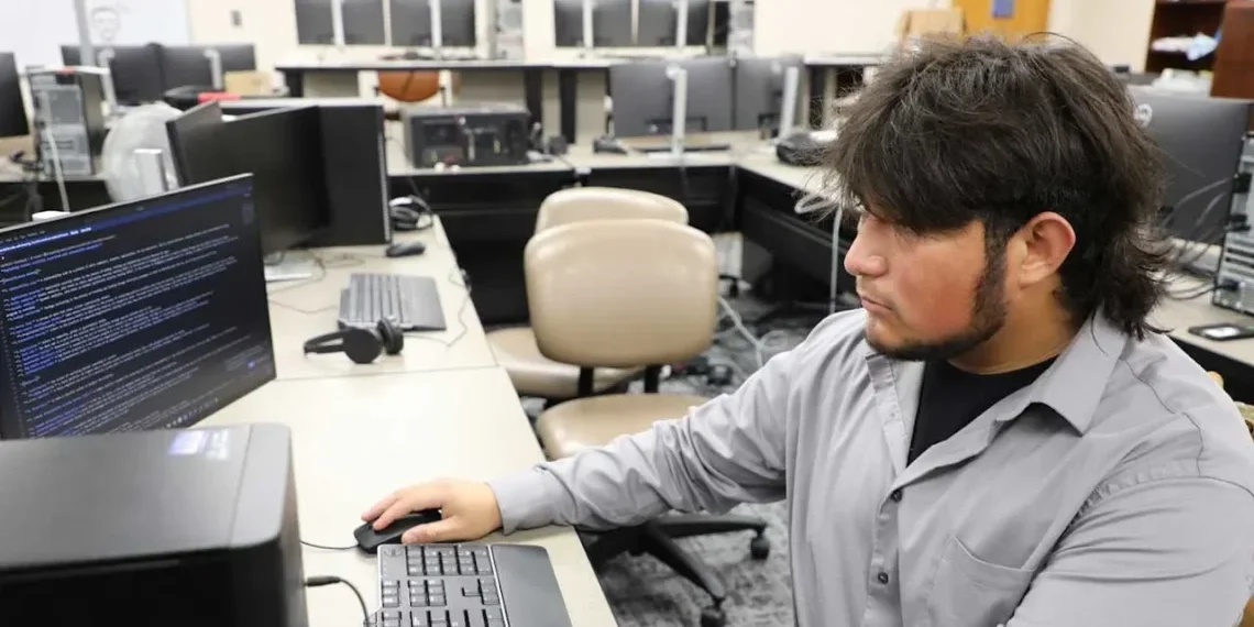 Student working on computer systems in an IT lab
