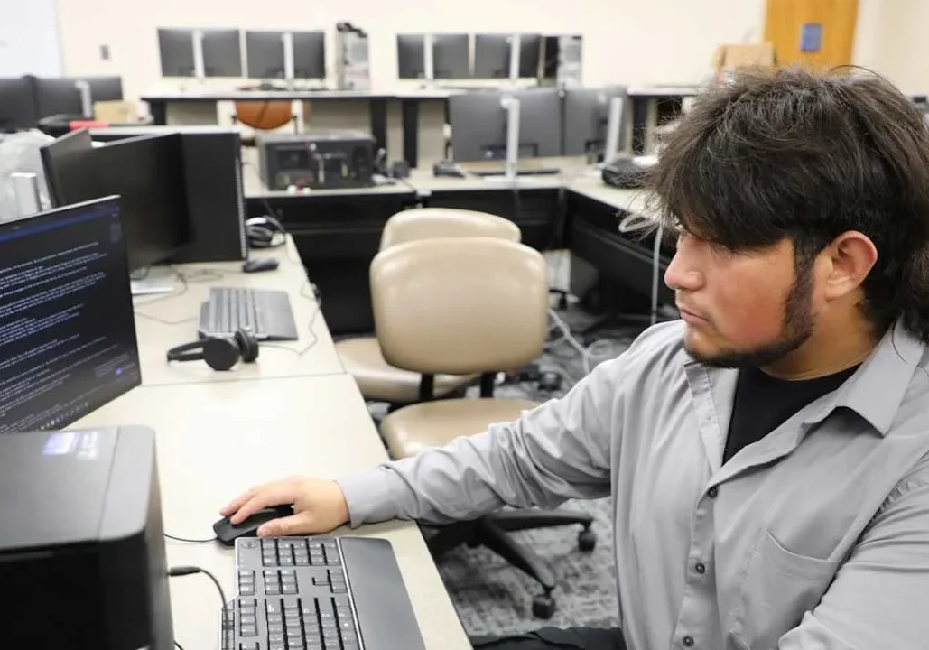 IT Pic Student working on computer systems in an IT lab